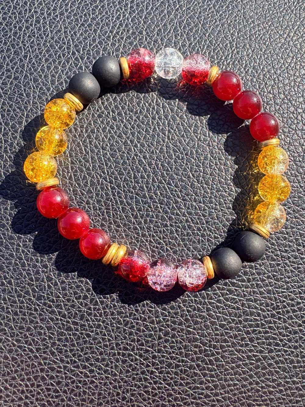 Red, Yellow, and Black glass Beaded bracelet with gold accents